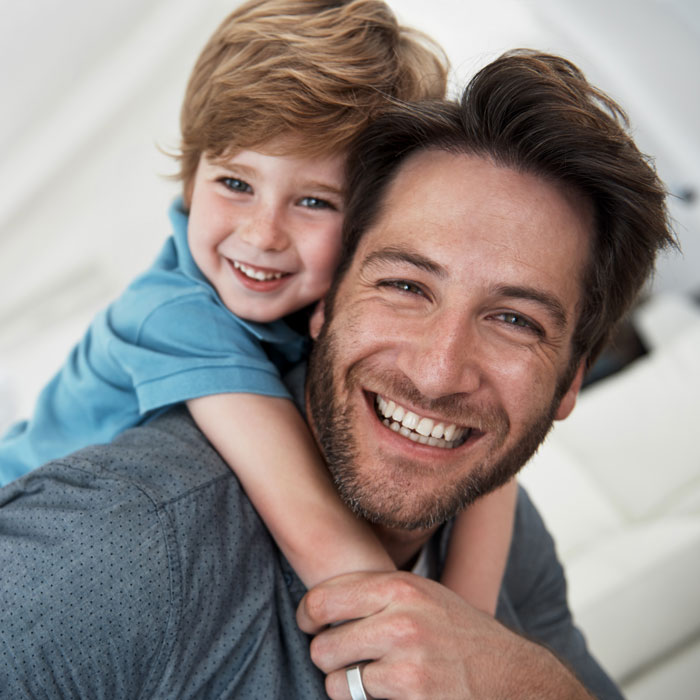 man and young son smiling